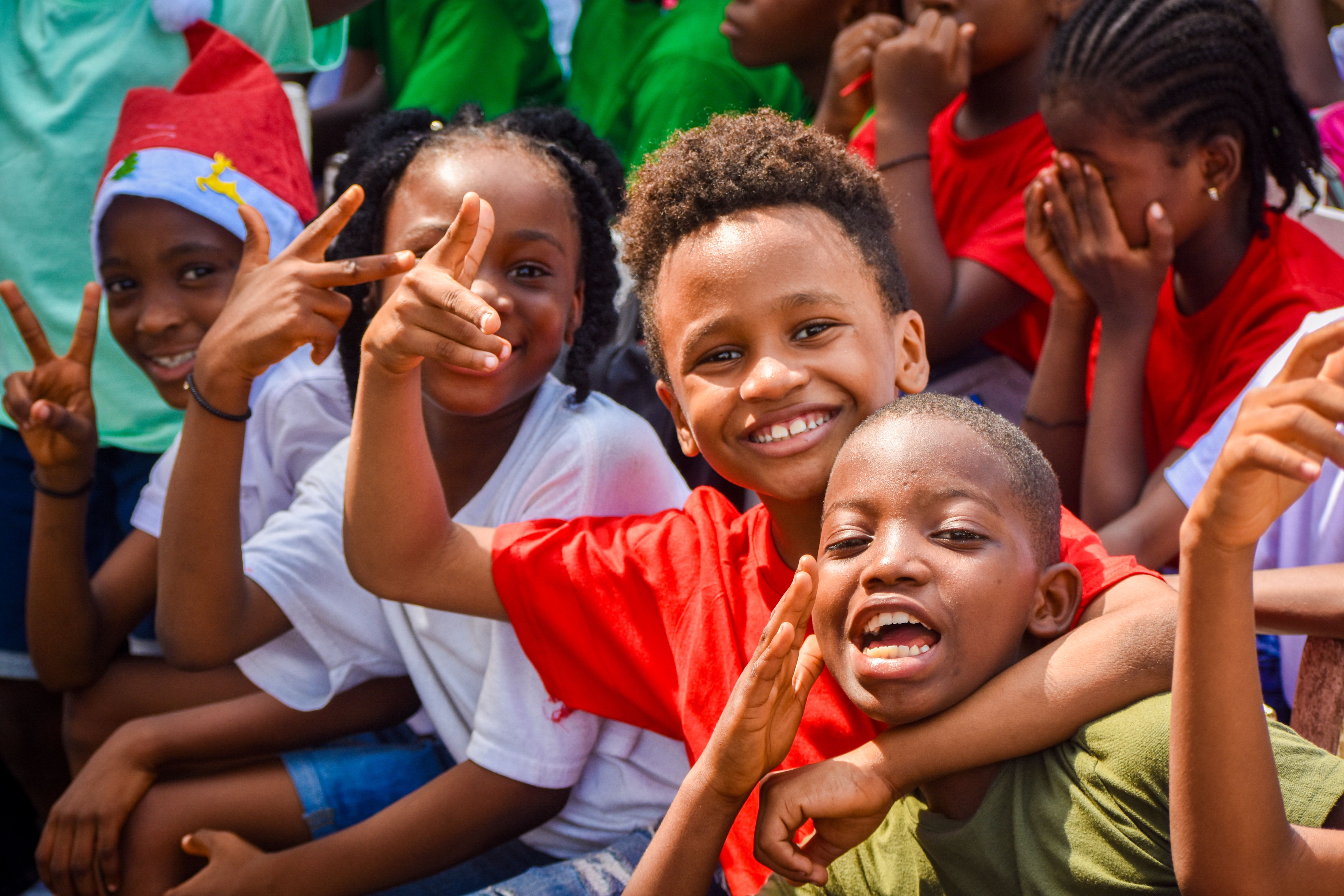 Children embracing warmly outdoors, reflecting the foundation's mission of dignity and belonging